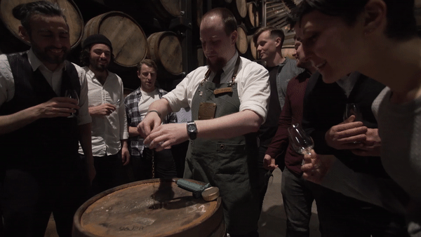 Guests learning about the whiskey making process in the Maturation room of the Jameson Distillery Bow St.